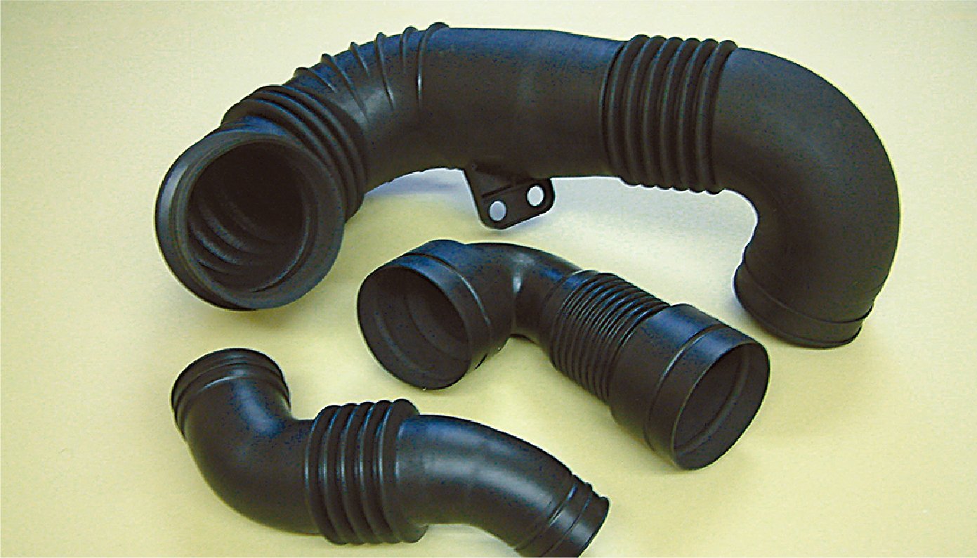 This is a black resin component shaped like two L-shaped valves connected by a bellows, with one large and two small valves lined up next to each other.