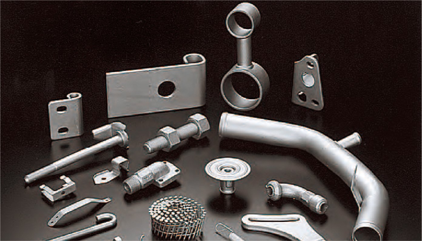 There are over a dozen metal parts lined up, which have been treated to prevent rusting and have turned a silvery gray.