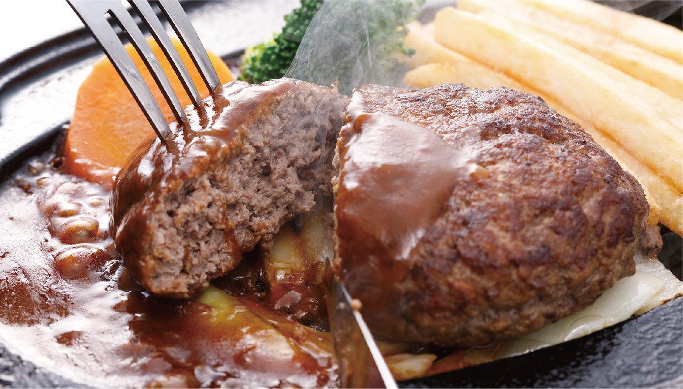 I cut the hamburger steak with demi-glace sauce into thirds using a fork and knife.